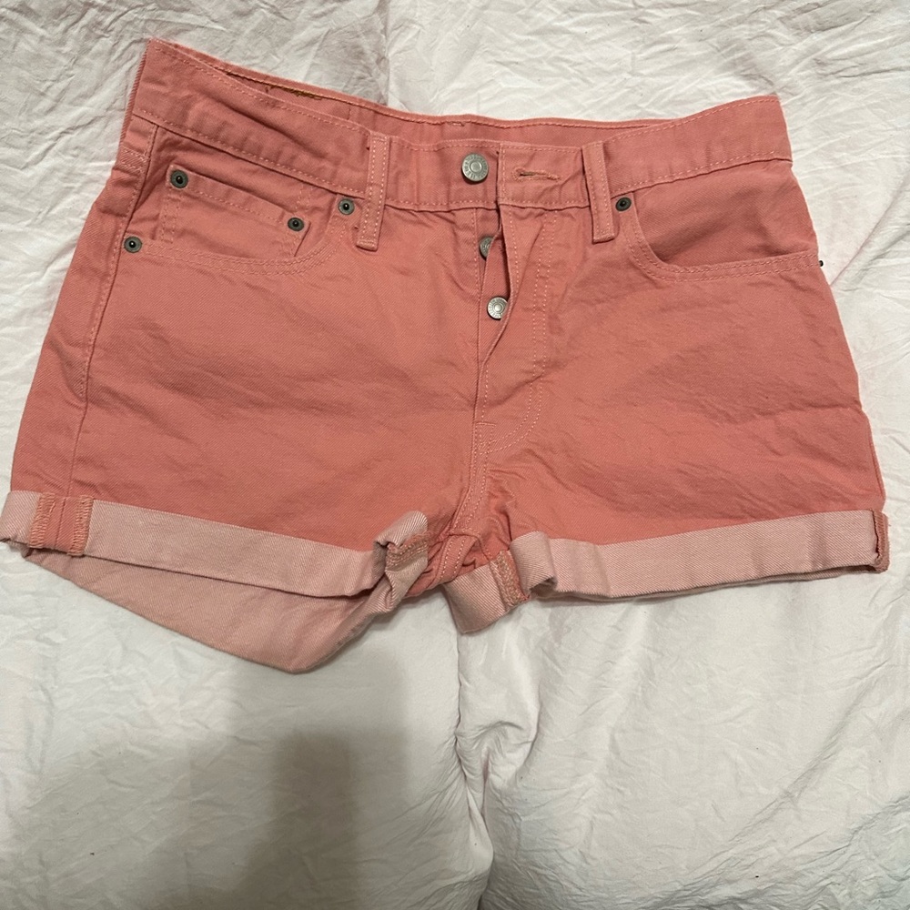 Levi Pink shorts with 3 buttons in the front.